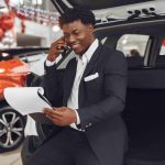 A man looking at car ownership documents